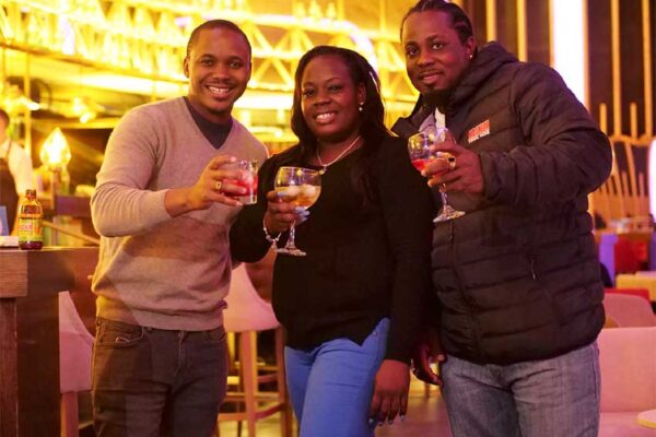 Image: (L-R) Magnum Tonic Wine’s Brand Marketing Manager for the Region, Kamal Powell shares smiles and a cocktail with the lucky winner from St Lucia, Sherma Joseph and her guest, Ernilius Bennett.