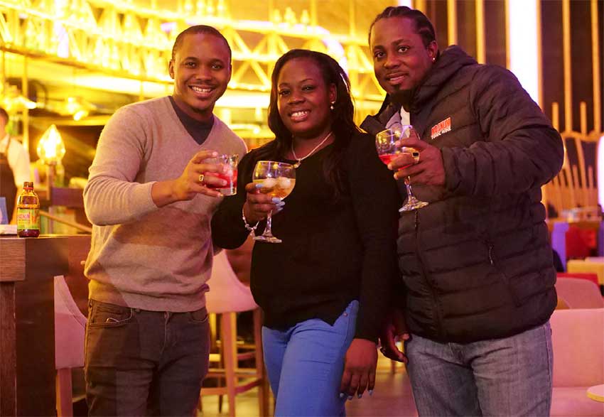 Image: (L-R) Magnum Tonic Wine’s Brand Marketing Manager for the Region, Kamal Powell shares smiles and a cocktail with the lucky winner from St Lucia, Sherma Joseph and her guest, Ernilius Bennett. 