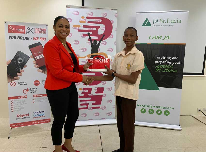 Image of Michael Stanislaus of CSS receiving prize from Cindy-Ann Gilbert, Sales and Marketing Manager of The Cell. 