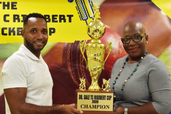 Image: (L-R) Tournament coordinator and former West Indies orthodox spinner, Garey Mathurin and Parliamentary representative for Micoud North, Dr. Gale Rigobert unveil the championship trophy. (PHOTO: Anthony De Beauville)