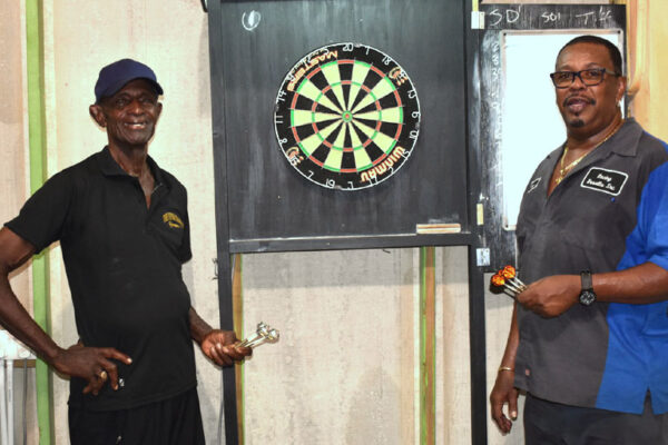 Image: (L-R) A photo moment for Gerald Cyril and close friend Denis ‘Prio’ Louis at the official Darts 501 Classic. (Photo: Anthony De Beauville)