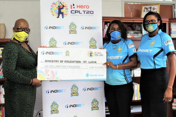 Image: (l-r) Minister for Education, Gale Rigobert receiving the US$10,000 dollars from Saint Lucia Zouks and Indibet representative, Sue Monplaisir (Photo: SM)