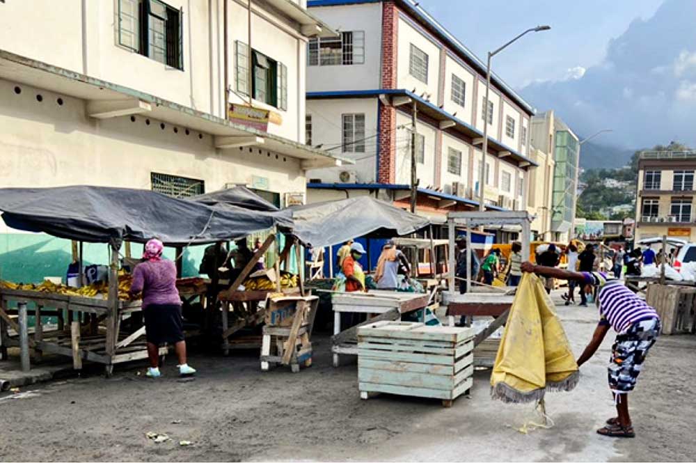 Image: Vendors at a market in Kingstown, St. Vincent begin to shake off the dust of the La Soufriere eruption. Photo Credit: Kenton Chance, iWitness News.