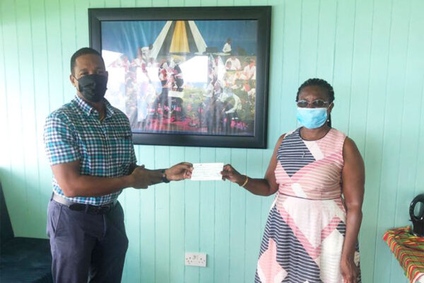 “Unity” President Felicia Hippolyte Presented a Cheque to the School of Music Director, Richard Payne.