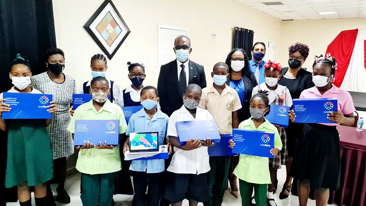 Students displaying the e-tablets that were handed over by Prime Minister Philip J Pierre. 
