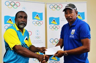 (from left and right) – SLOC Inc. President Alfred Emmanuel presenting a cheque to SLRFU’s Technical Director, Wayne Pantor.