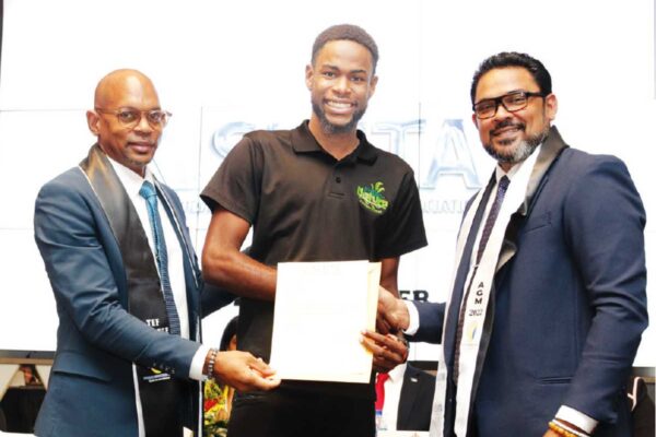 Mathurin (centre) accepting his complimentary membership letter from SLHTA’s CEO Senitor Noorani Azeez (R) and President Paul Collymore (L)