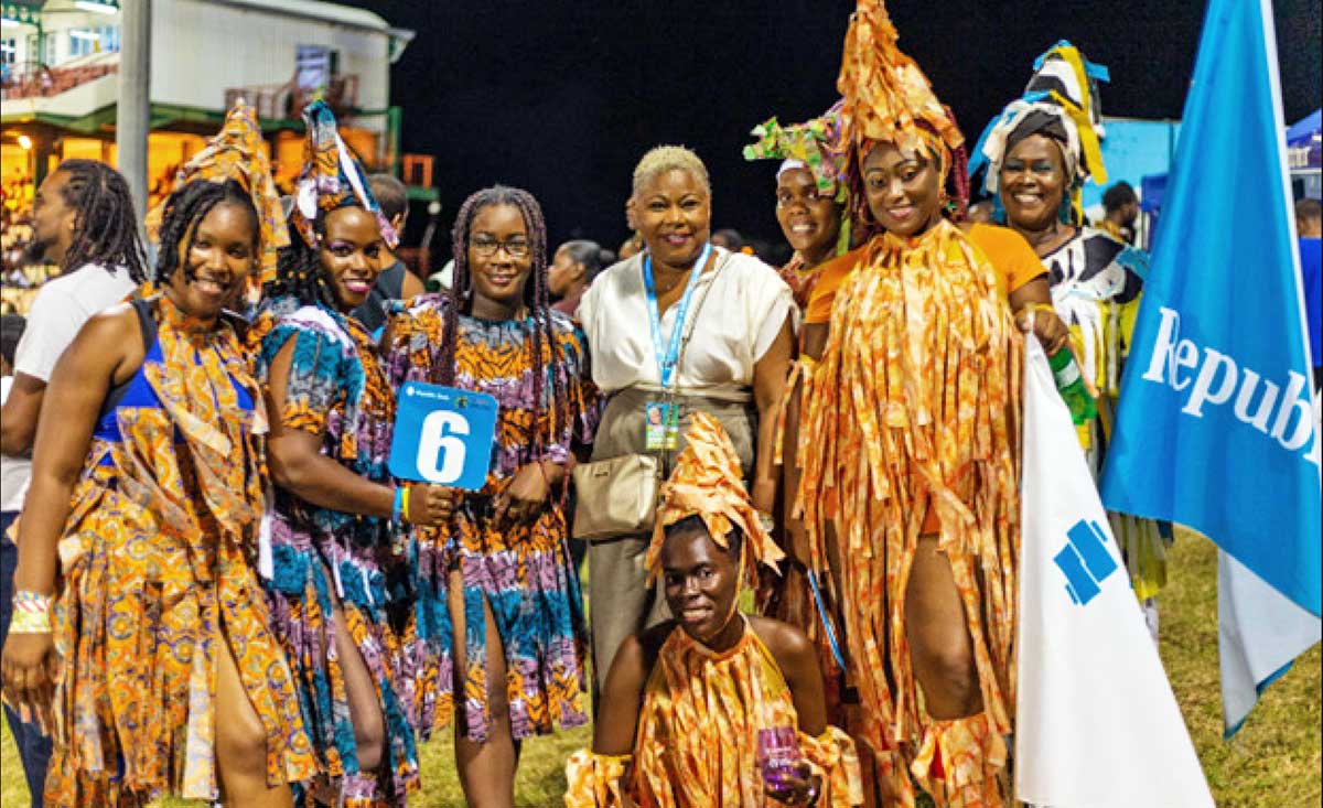 Performers from Mystic Rhythms with Managing Director of Republic Bank in the Eastern Caribbean, Michelle Palmer-Keizer.