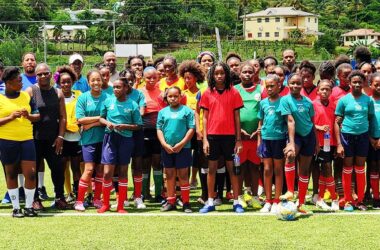 Coaches, coordinators and players gather for a photo-opportunity at the Technical Centre during the Girls Football Fiesta program.