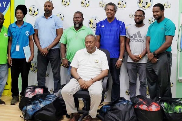 Coaches with SLFA Inc. President Lyndon Cooper (seated) and Program coordinator John Sealy (extreme left).