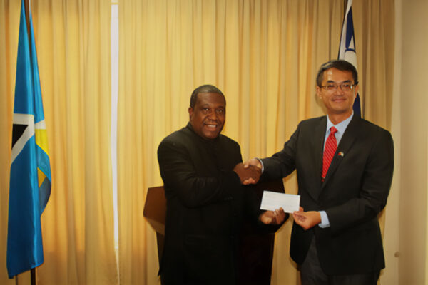 Taiwan’s Ambassador to Saint Lucia, His Excellency Peter Chia-yen Chen, presents the cheque to Hon. Alva Baptiste, Minister for External Affairs, International Trade, Civil Aviation & Diaspora Affairs, at Thursday’s handing over ceremony.