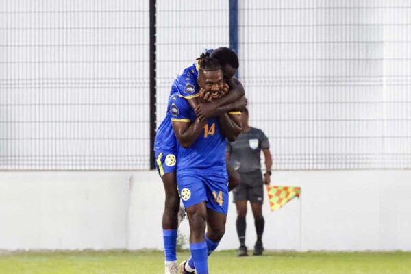 Prolific Saint Lucian striker Dom Poleon is mobbed by teammates after scoring against Sint Martin