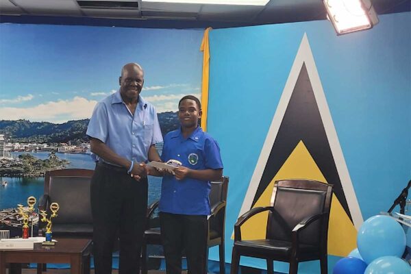 Vice President of the St. Lucia Diabetes and Hypertension Association Tedburt Theobalds (L) with the winner of the National Primary Schools Diabetes Quiz Competition Shanil Solomon of the Soufriere Primary School.