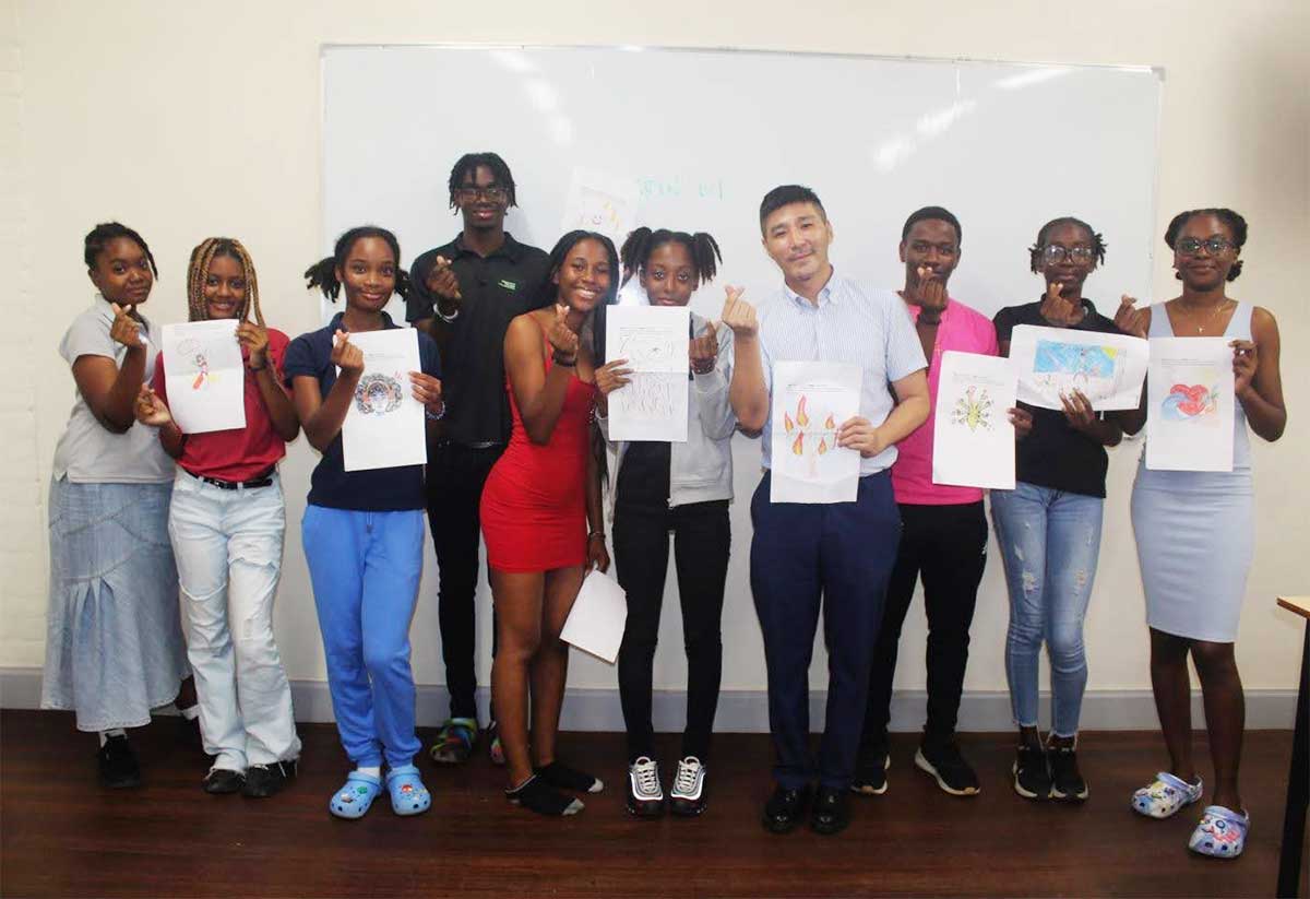 Mandarin teacher, Mr. Andres Chi, fourth from right, with nine of the eleven students from the Functional Mandarin 101 Course following their final presentation for the semester on Tuesday, December 12, 2023.