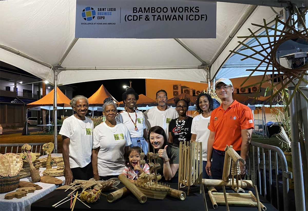 H.E. Peter Chia-Yen Chen, Taiwan’s Ambassador to Saint Lucia, and Mrs. Chen join some of the Bamboo Works workshop participants in their booth at the Taste of Saint Lucia Expo in Rodney Bay.