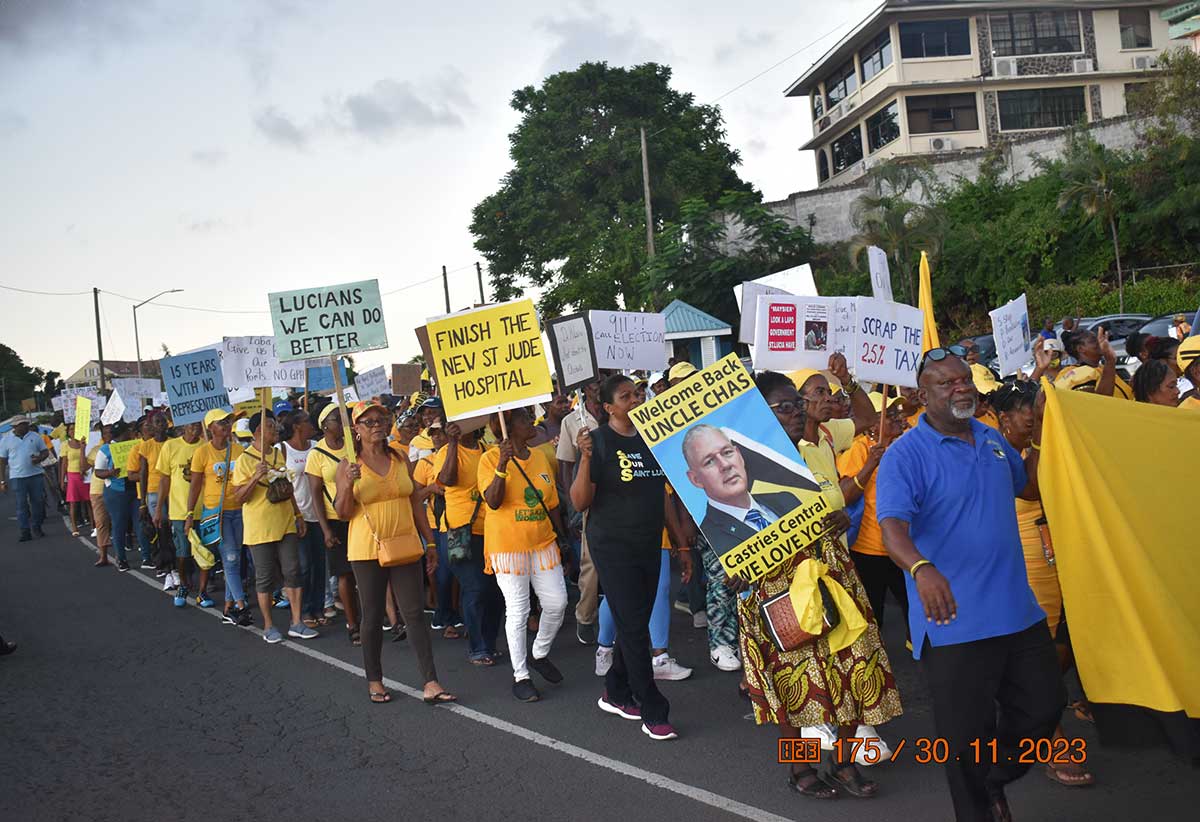 UWP supporters marching from the Saab Playing Field to the Williams Peter Boulevard Thursday afternoon in a move to protest government’s handling of the economy