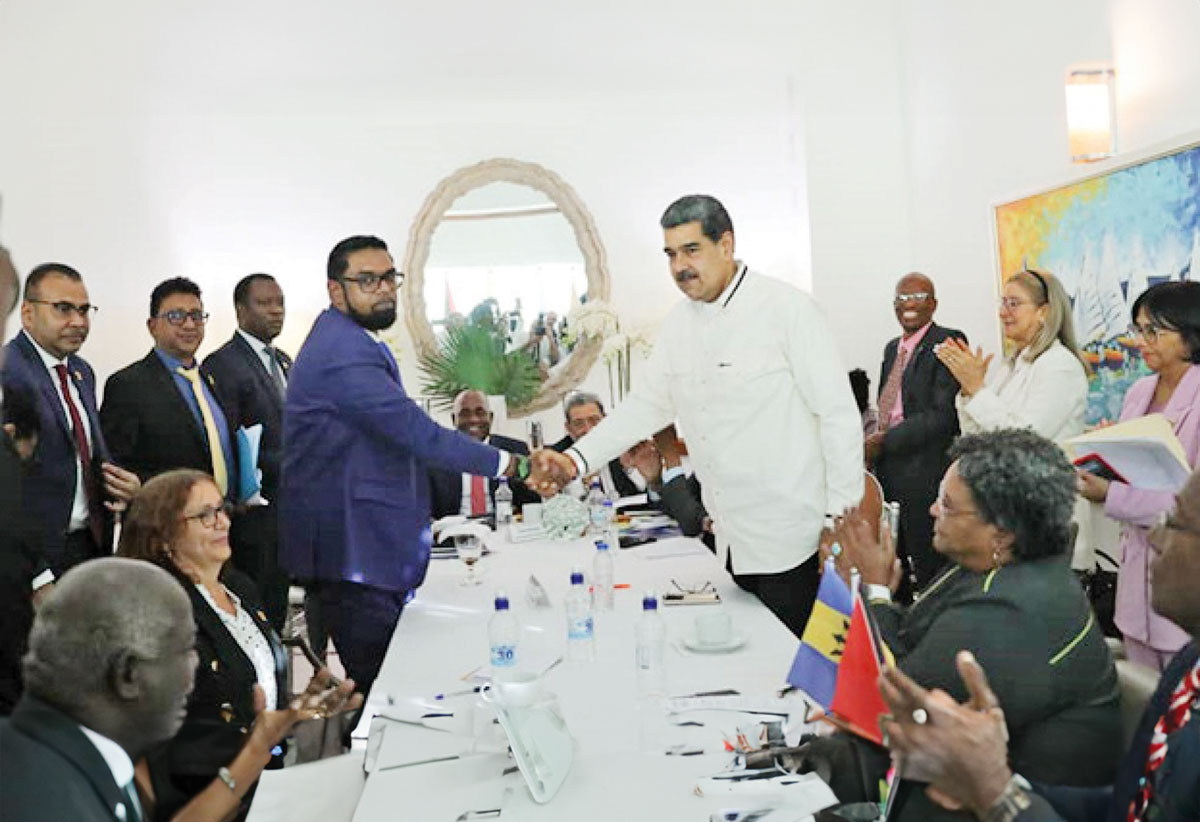 Venezuelan President Nicolas Maduro, right, and Guyanese President Irfaan Ali shake hands ahead of talks over Essequibo 