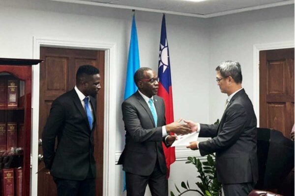 H.E. Peter Chia-Yen Chen, Taiwan’s Ambassador to Saint Lucia, far right, presents a check for the three bilateral cooperation projects to Hon. Philip J. Pierre, Prime Minister and Minister for Finance, Economic Development and the Youth Economy & Minister for Justice and National Security, centre, on Monday, January 22, 2024. At far left is Mr. Matthew Branford, Accountant General.