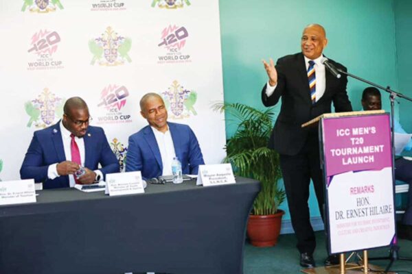 Tourism Minister Ernest Hilaire addressing the gathering. Sitting are Sports Minister Kenson Casimir (far left) and SLNCA President Wayne Auguste.