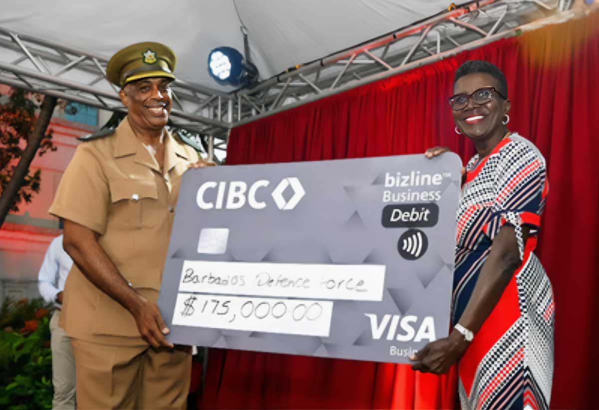 Comtrust Foundation Director Lynda Goodridge presents the funds to Major David Clarke of the Barbados Defence Force. Major Clarke is the Coordinator for the Field Hospital.