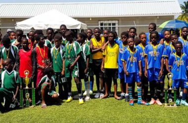 Finalists in the Inter Primary Schools Football – District 5 (left) and District 8 (right) display their respective trophies