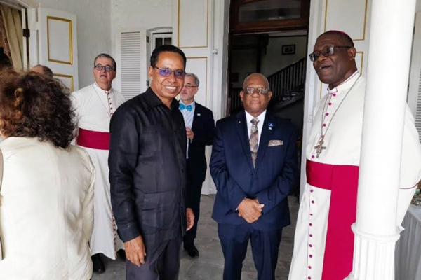 Governor General Errol Charles (center) and Archbishop Gabriel Malzaire (right) with Barbados High Commissioner David Commissiong (left, in black)