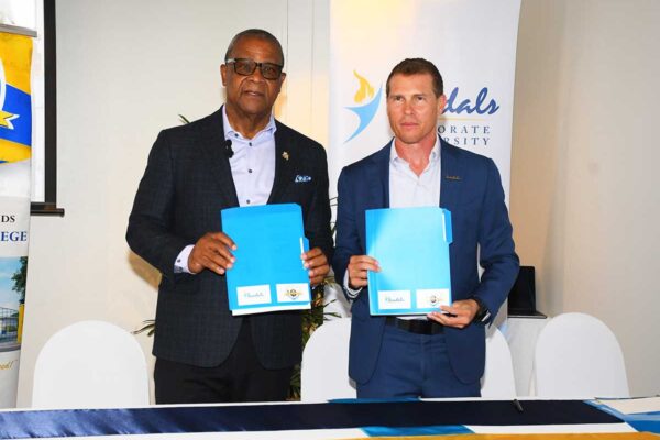 MOU TCI 2 – Captured after the signing the Memorandum of Understanding are the Hon. Charles Misick, premier of the Turks and Caicos Islands alongside Mr. Adam Stewart, executive chairman of Sandals Resorts International. This two-year agreement will assist the TCICC in strengthening its Hospitality and Tourism Programme to build local capacity and develop leadership in the industry from within the Turks and Caicos Islands.