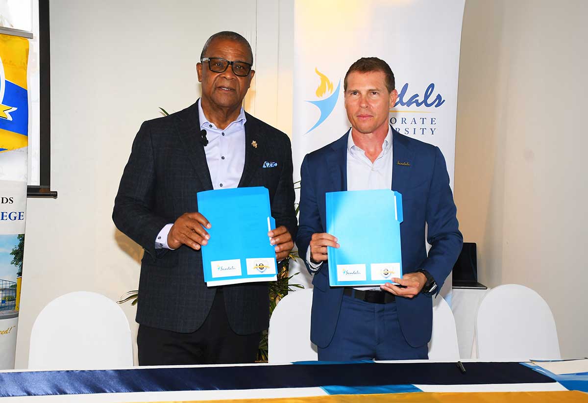 MOU TCI 2 – Captured after the signing the Memorandum of Understanding are the Hon. Charles Misick, premier of the Turks and Caicos Islands alongside Mr. Adam Stewart, executive chairman of Sandals Resorts International. This two-year agreement will assist the TCICC in strengthening its Hospitality and Tourism Programme to build local capacity and develop leadership in the industry from within the Turks and Caicos Islands.