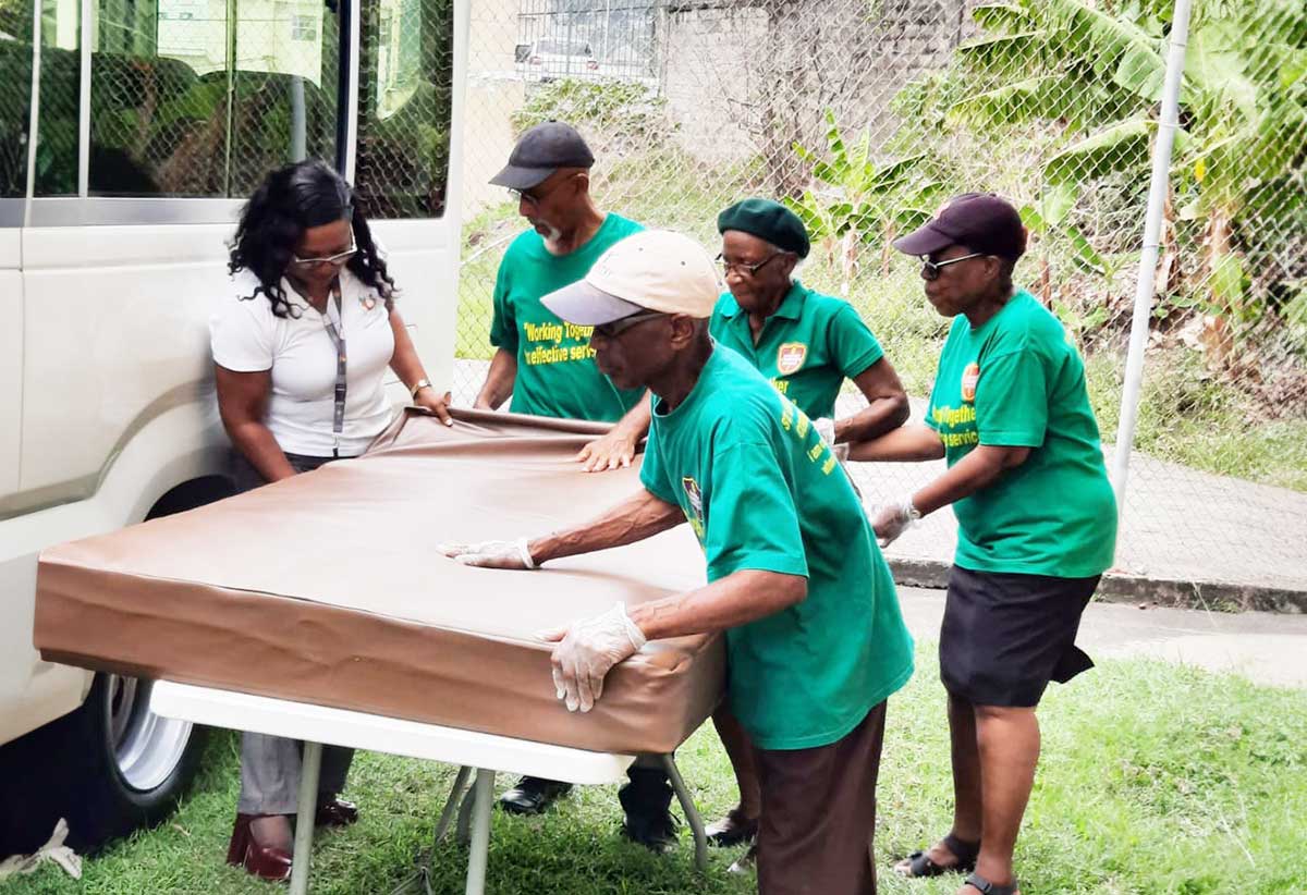 Participants in the National Day of Caring initiative provide bedding covers for vulnerable persons. 