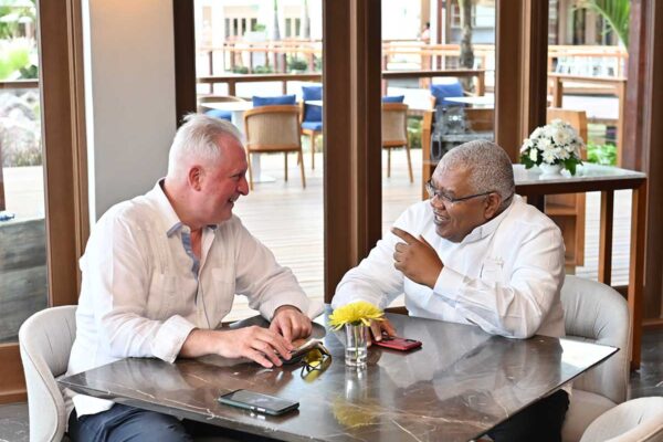 From L to R: interCaribbean Airways CEO Trevor Sadler speaks with Gary Sadler, Executive VP of Sales and Industry Relations at Unique Vacations Inc., an affiliate of the worldwide representatives of Sandals and Beaches Resorts