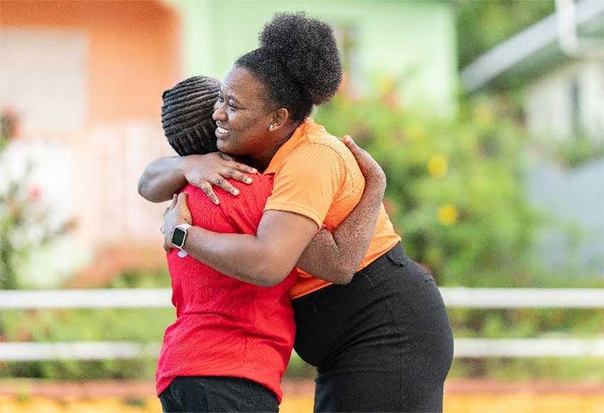 An employee of Massy Stores celebrating the Forces for Good grant to the St. Lucia Sickle Cell Association alongside the organization's president, Sophia Harry.