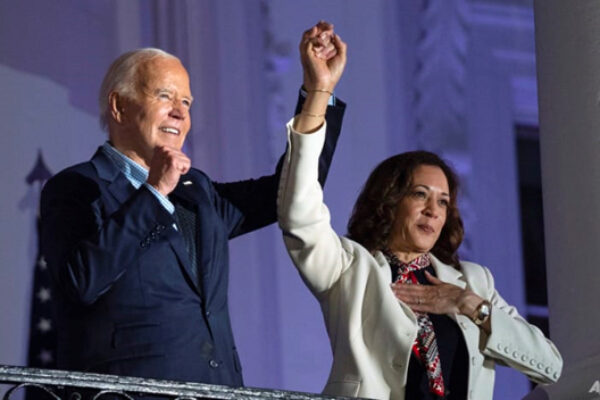 President Joe Biden raises the hand of Vice President Kamala Harris after viewing the Independence Day fireworks display over the National Mall from the balcony of the White House, on Jul 4, 2024, in Washington. (AP Photo/Evan Vucci)