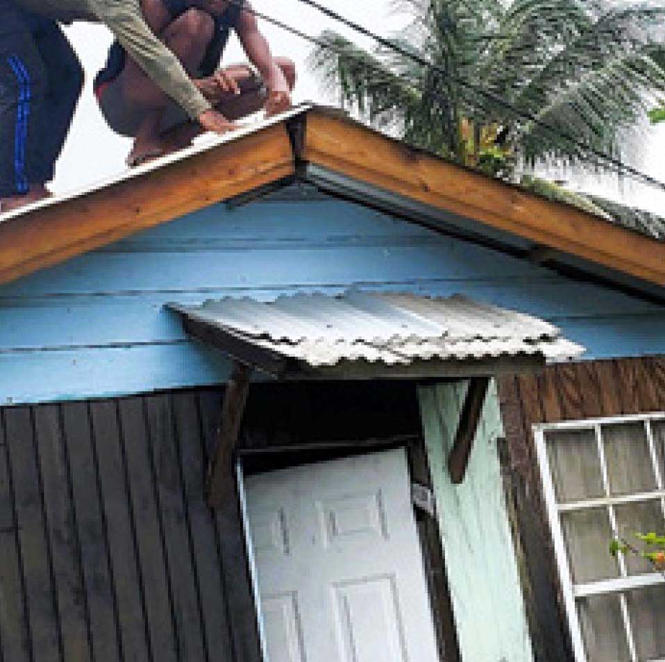 BTC wards assisting a staffer whose home was damage by Hurricane beryl