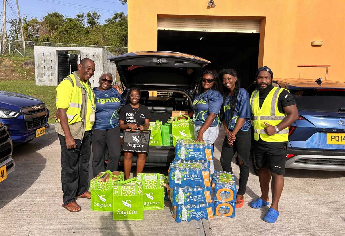 SAGICOR SUPPORTS: Members of Team Sagicor Grenada support the Hurricane Beryl relief effort with the donation of water and canned items to representatives of the National Disaster Management Agency