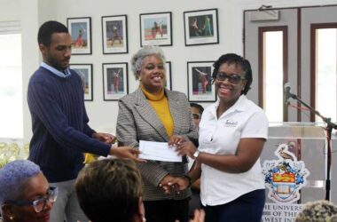 (left-right): Mr. Joshua Bishop, Alumni Assistant, Mrs. Sandra Griffith-Carrington, Campus Alumni Office and Coordinator, ‘Preparing Today for Tomorrow’s Challenges’, The UWI Global Campus receiving the donation from Ms. Stacia Brathwaite, Public Relations Coordinator, Sandals Resort & Spa.