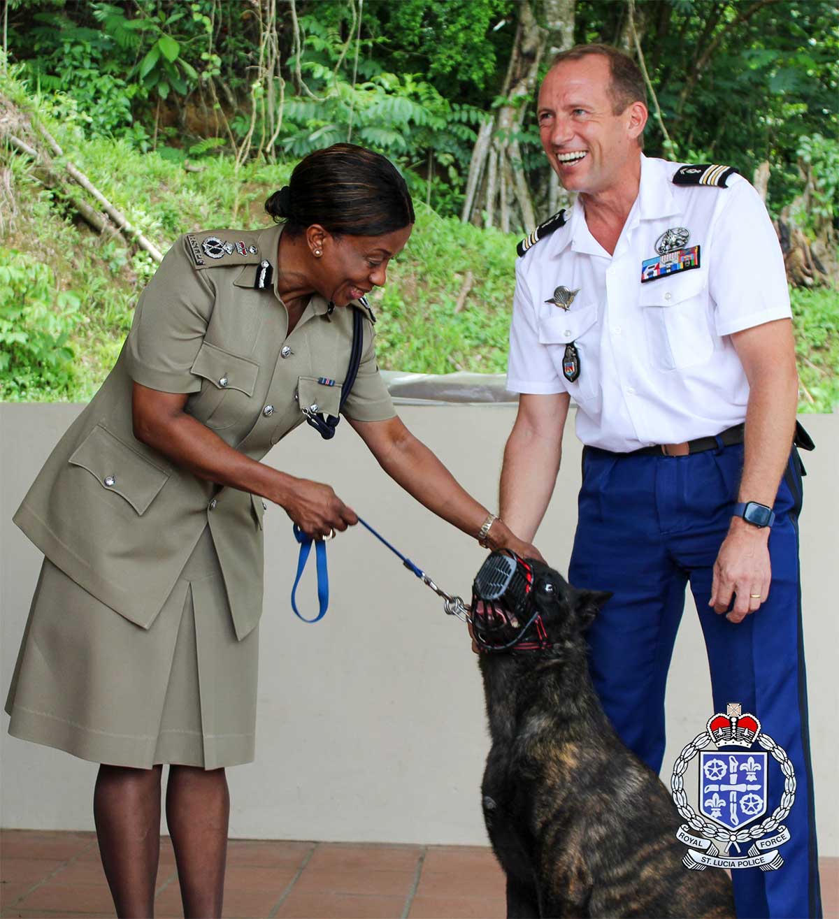 Police Commissioner Crusita Pelius petting the K9. Looking on is the K-9’s handler