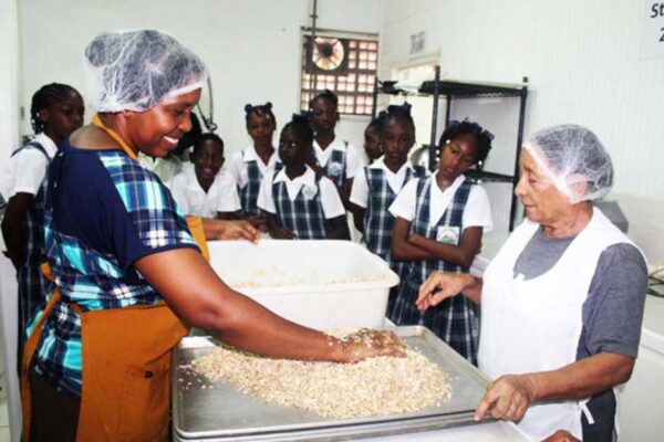 Students getting a firsthand look as the female entrepreneurs from Rainforest Foods produce granola