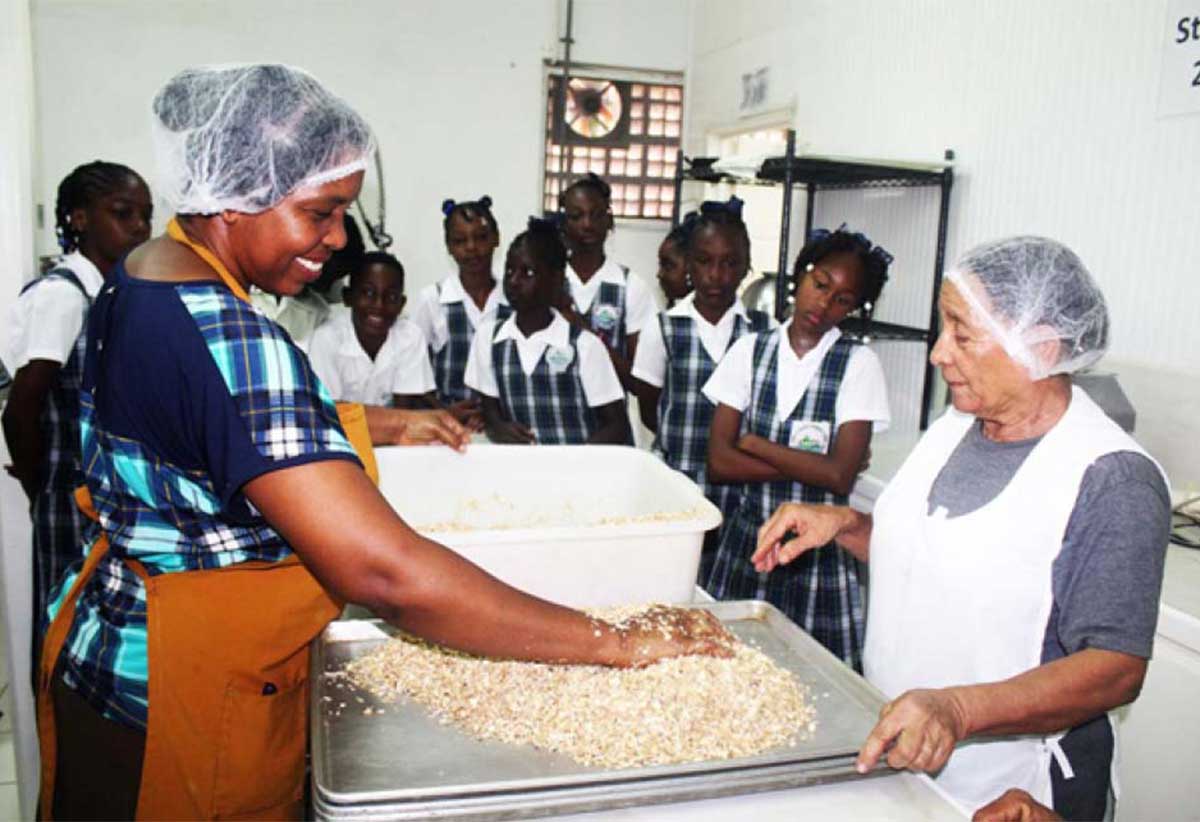 Students getting a firsthand look as the female entrepreneurs from Rainforest Foods produce granola