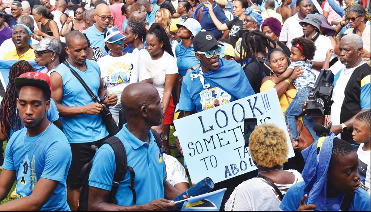 A section of the watch party at the Derek Walcott Square cheering Alfred to her silver medal in the Women’s 200 metres final. Inset: Julien Alfred