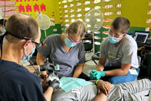 Great Shape! Inc. dental professionals and volunteers treating a patient at a free clinic