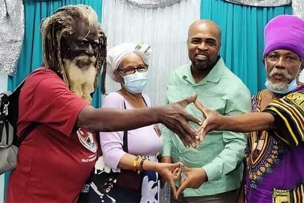 Minister Joachim Henry (second from right) meets members of the Rastafarian community