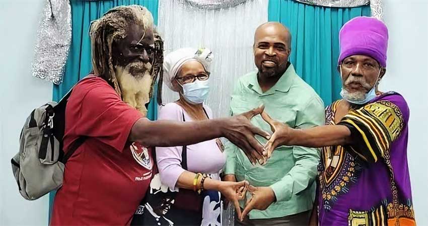 Minister Joachim Henry (second from right) meets members of the Rastafarian community 