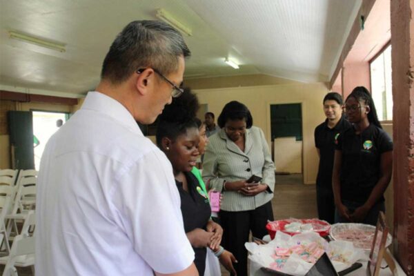 H.E. Peter Chia-Yen Chen, Taiwan’s Ambassador to Saint Lucia, and Hon. Emma Hippolyte, Minister for Commerce, engage summer camp participants during a tour