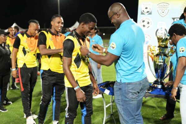 La Clery players collecting their gold medals from Sports Minister Kenson Casimir