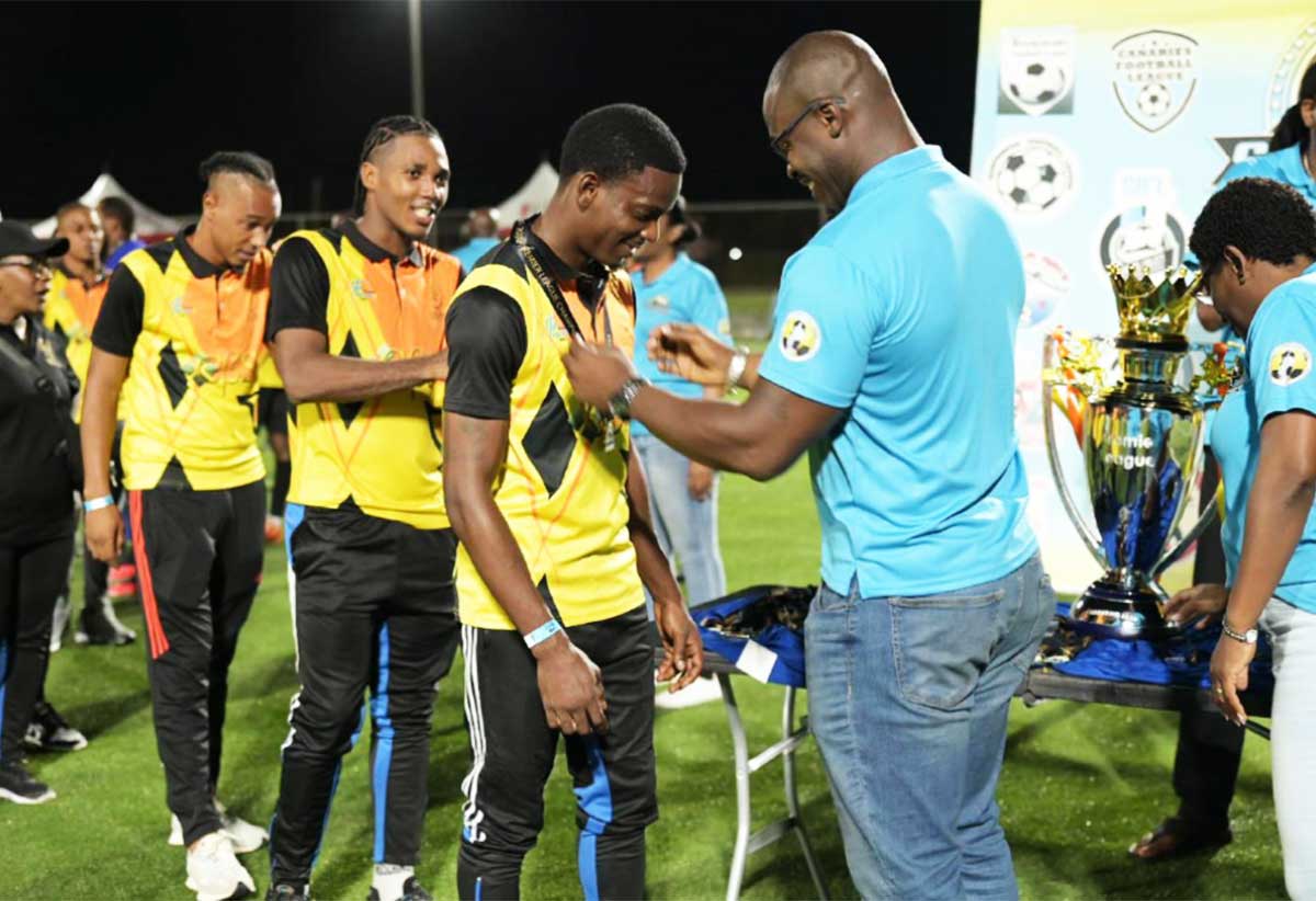 La Clery players collecting their gold medals from Sports Minister Kenson Casimir