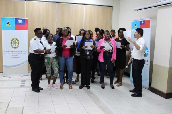 Mr. Andres Chi, Mandarin Teacher at the Taiwan Technical Mission, at far right, joins participants in performing a song in Mandarin at the certificate ceremony for the Basic Mandarin Course on Friday, October 4, 2024.