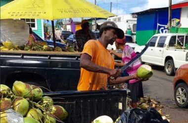 A coconut vendor plying his trade