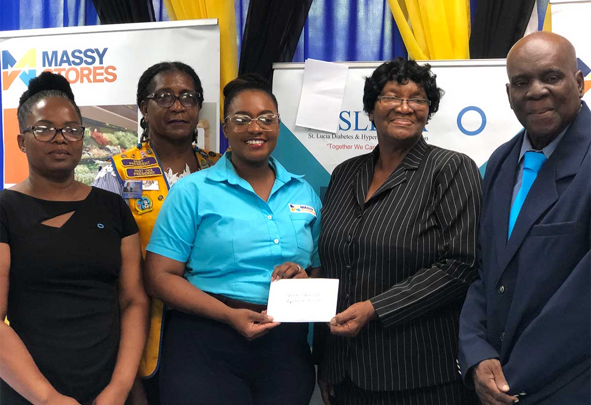 Kittel Raphael-Dubois, Marketing and Corporate Communications Officer at Massy Stores (third from left) presents an $8000.00 cheque to the SLDHA members