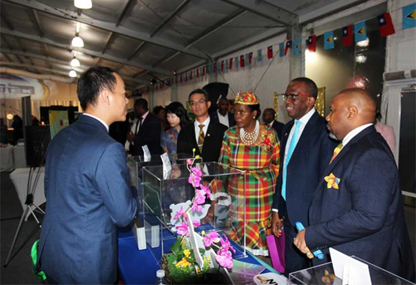 H.E. Peter Chia-Yen Chen, Taiwan’s Ambassador to Saint Lucia, and Mrs. Chen join Hon. Philip J. Pierre, Prime Minister and Minister for Finance, Economic Development and Youth Economy, and Minister for Justice and National Security; Hon. Emma Hippolyte, Minister for Commerce, Manufacturing, Business Development, Cooperatives and Consumer Affairs; and Mr. Esli Lafeuillee, Director of Commerce & Industry Unit; for a tour of one of the Taiwanese businesses’ booths following the opening ceremony on Thursday evening, October 31, 2024, at The Pavilion on the Ramp, Rodney Bay