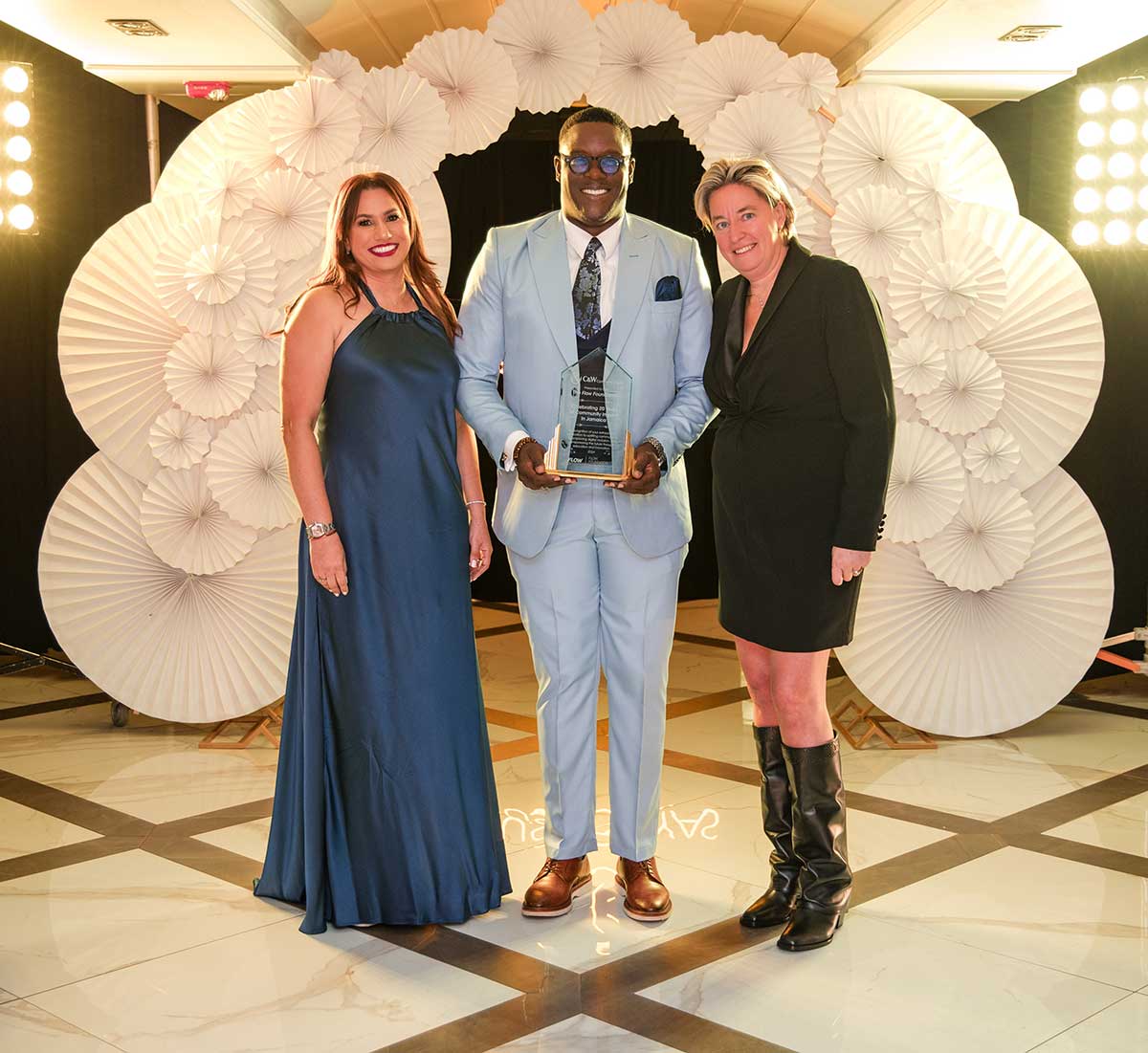 Stephen Price (centre), General Manager of Flow Jamaica, receives a special award on behalf of the Flow Foundation from Inge Smidts (right), Chief Executive Officer, C&W Communications, and Rosario Veras, Executive Director of the Cable & Wireless Charitable Foundation.